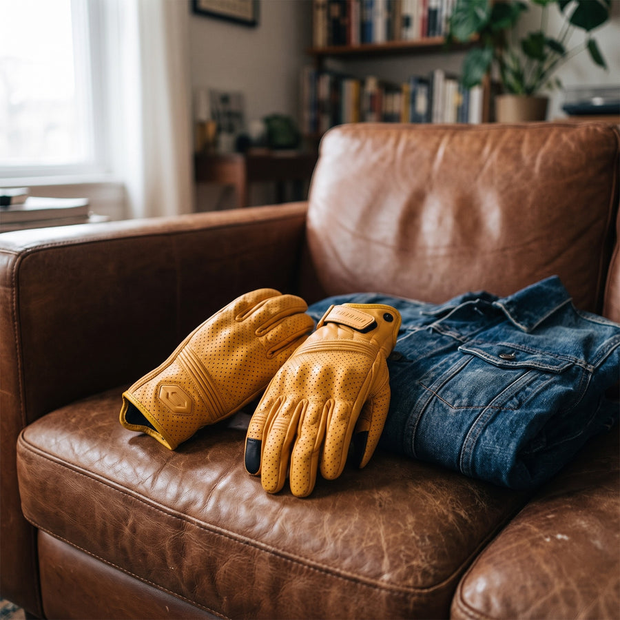 AtomBiker Maverick tan leather motorcycle gloves on a leather couch