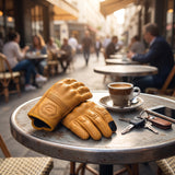 AtomBiker Maverick gloves on a cafe table with espresso and keys